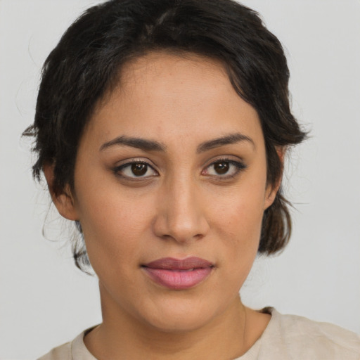 Joyful latino young-adult female with medium  brown hair and brown eyes
