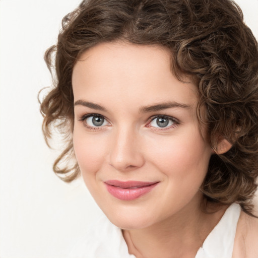 Joyful white young-adult female with medium  brown hair and green eyes