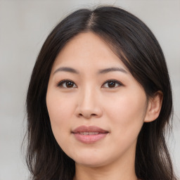 Joyful asian young-adult female with long  brown hair and brown eyes