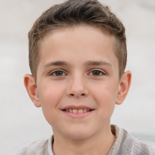 Joyful white child male with short  brown hair and grey eyes