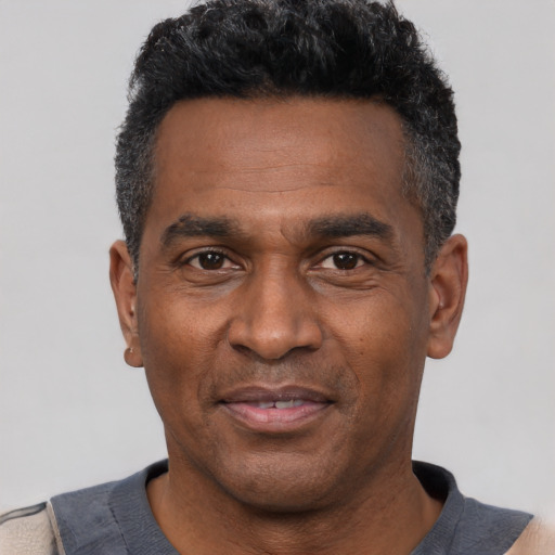 Joyful latino adult male with short  black hair and brown eyes