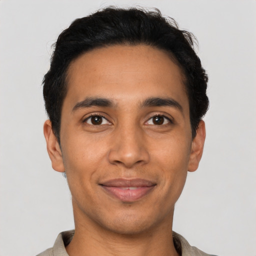 Joyful latino young-adult male with short  black hair and brown eyes