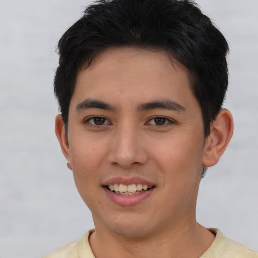 Joyful asian young-adult male with short  brown hair and brown eyes