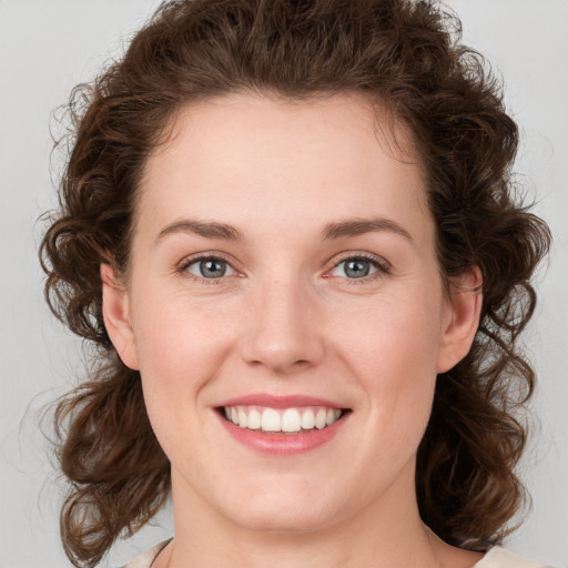 Joyful white young-adult female with medium  brown hair and green eyes