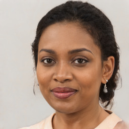 Joyful black young-adult female with medium  brown hair and brown eyes