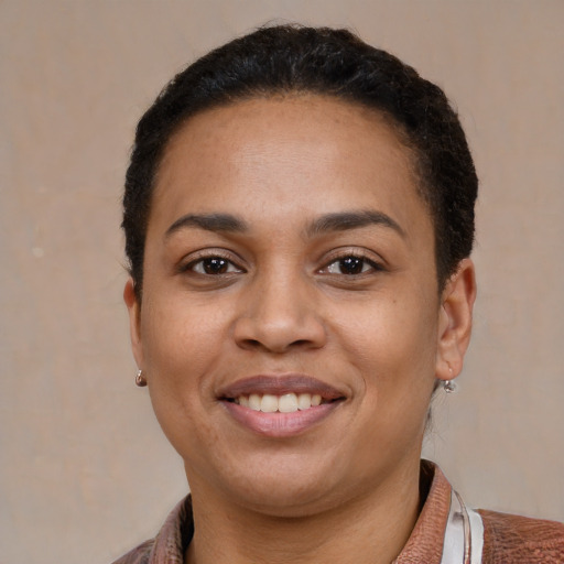 Joyful latino young-adult female with short  brown hair and brown eyes