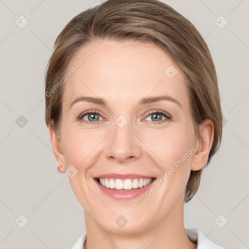 Joyful white young-adult female with medium  brown hair and grey eyes