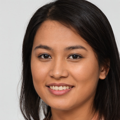 Joyful asian young-adult female with long  brown hair and brown eyes