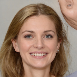 Joyful white young-adult female with medium  brown hair and blue eyes