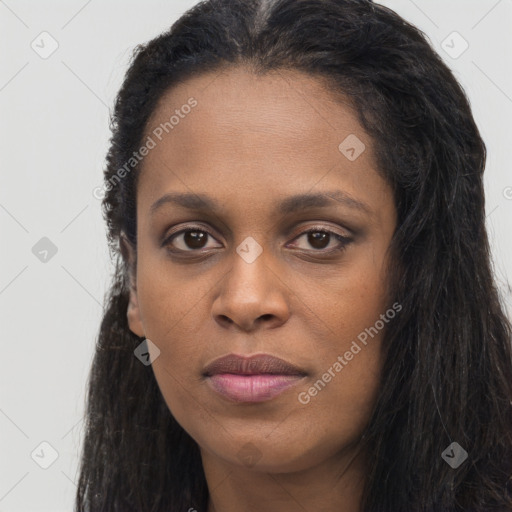 Joyful black young-adult female with long  black hair and brown eyes