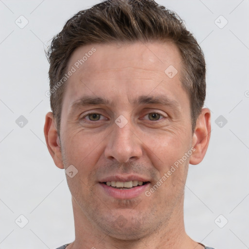 Joyful white adult male with short  brown hair and brown eyes