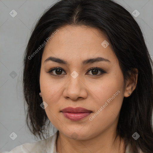 Joyful latino young-adult female with medium  brown hair and brown eyes