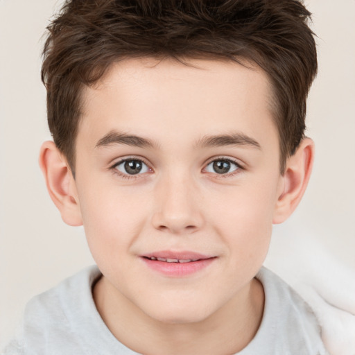 Joyful white child male with short  brown hair and brown eyes