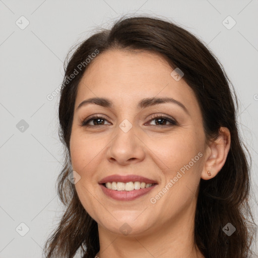 Joyful white young-adult female with long  brown hair and brown eyes