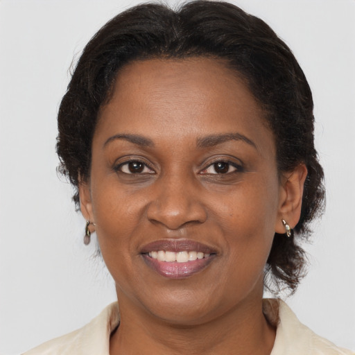 Joyful black adult female with medium  brown hair and brown eyes