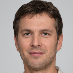 Joyful white adult male with short  brown hair and brown eyes