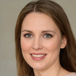 Joyful white young-adult female with long  brown hair and green eyes