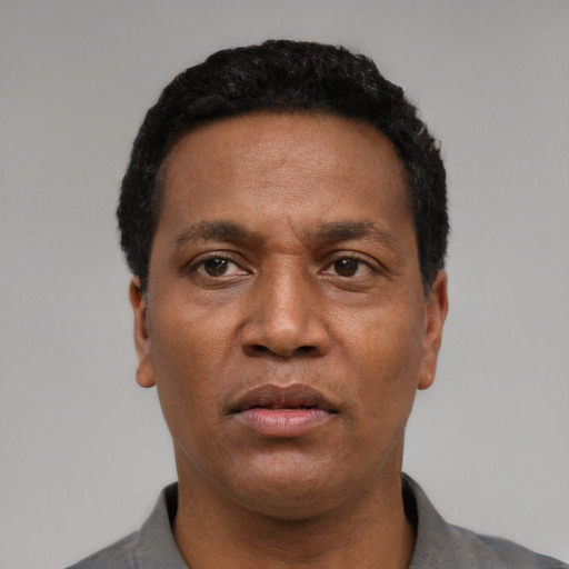 Neutral latino adult male with short  black hair and brown eyes