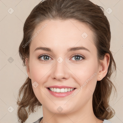 Joyful white young-adult female with medium  brown hair and green eyes