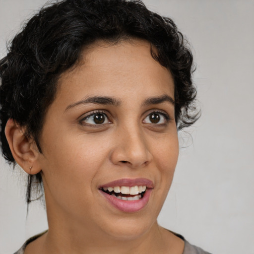 Joyful latino young-adult female with short  brown hair and brown eyes