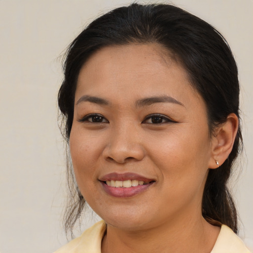 Joyful asian young-adult female with medium  brown hair and brown eyes