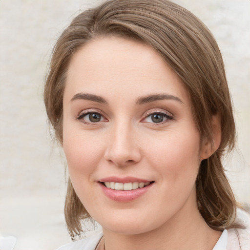 Joyful white young-adult female with medium  brown hair and blue eyes