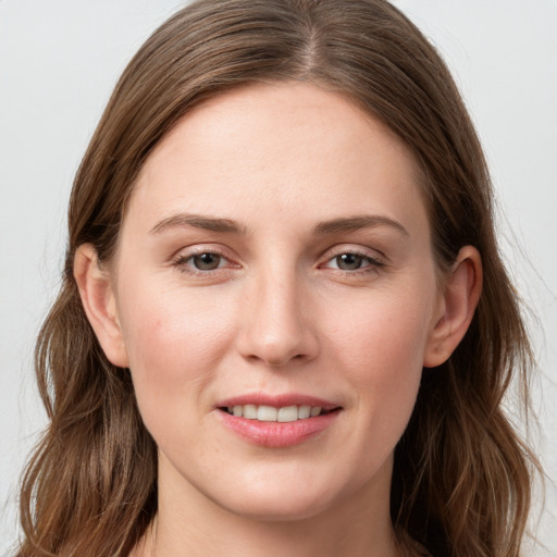 Joyful white young-adult female with long  brown hair and grey eyes