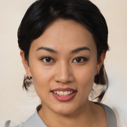 Joyful asian young-adult female with medium  black hair and brown eyes