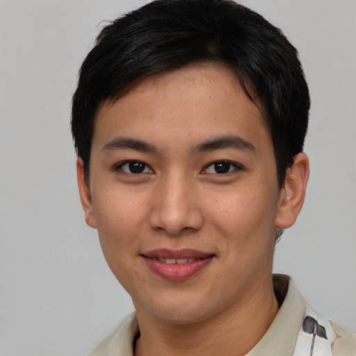 Joyful asian young-adult male with short  brown hair and brown eyes