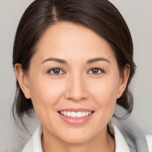 Joyful white young-adult female with medium  brown hair and brown eyes