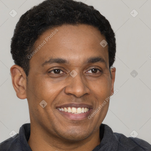 Joyful latino adult male with short  black hair and brown eyes