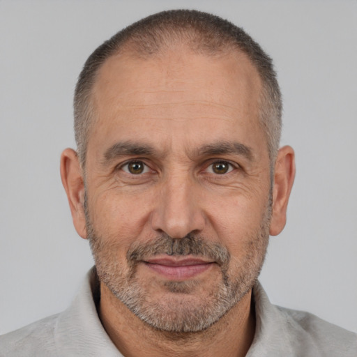 Joyful white middle-aged male with short  black hair and brown eyes