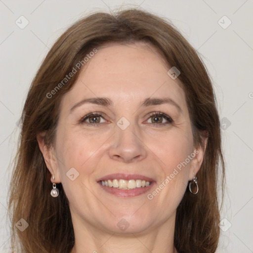 Joyful white adult female with long  brown hair and grey eyes