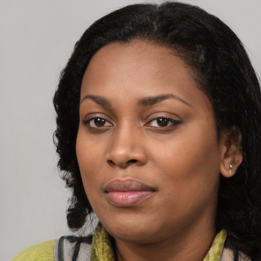 Joyful black young-adult female with medium  black hair and brown eyes