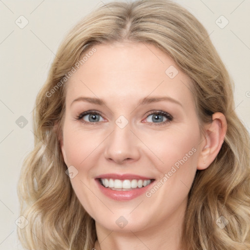 Joyful white young-adult female with long  brown hair and blue eyes