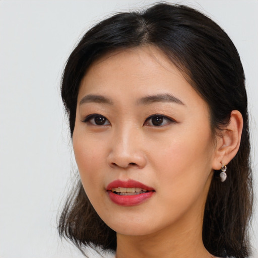 Joyful asian young-adult female with medium  brown hair and brown eyes