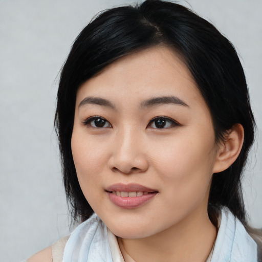 Joyful asian young-adult female with medium  black hair and brown eyes