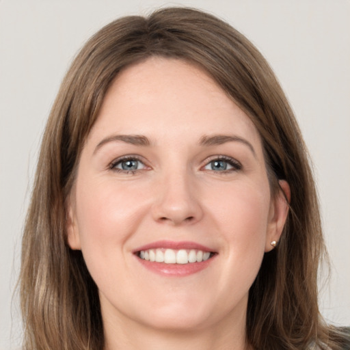 Joyful white young-adult female with long  brown hair and grey eyes