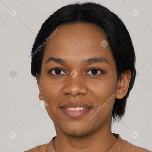 Joyful black young-adult female with short  black hair and brown eyes