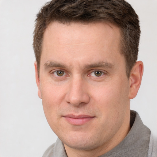 Joyful white adult male with short  brown hair and grey eyes