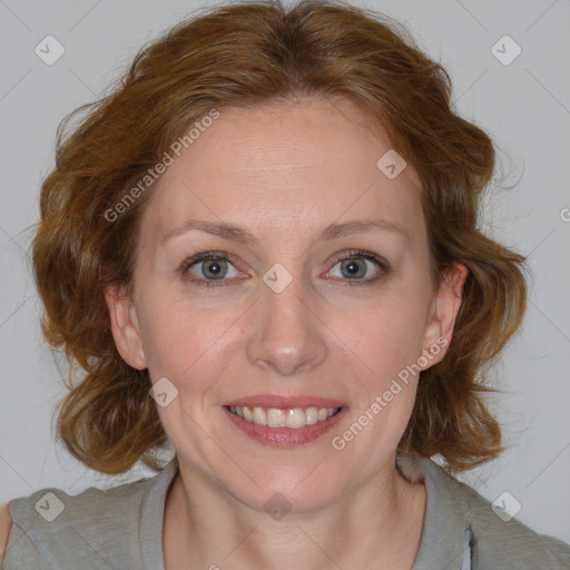 Joyful white adult female with medium  brown hair and blue eyes