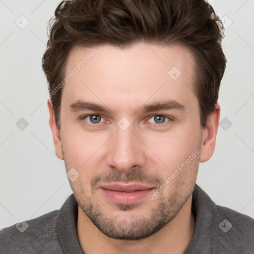 Joyful white young-adult male with short  brown hair and grey eyes