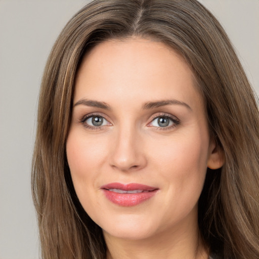 Joyful white young-adult female with long  brown hair and grey eyes