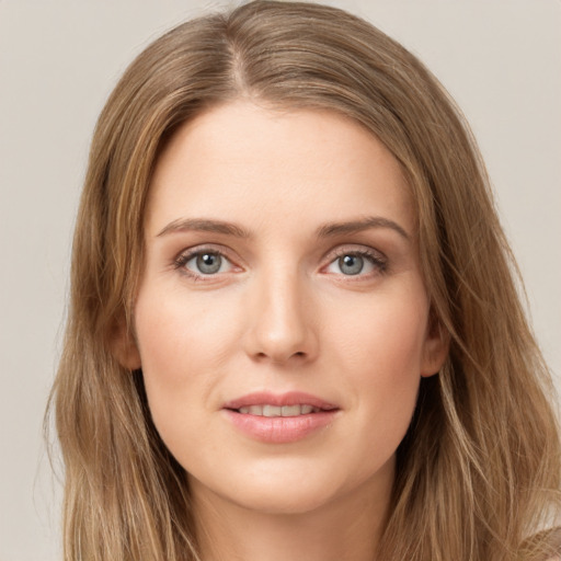 Joyful white young-adult female with long  brown hair and green eyes