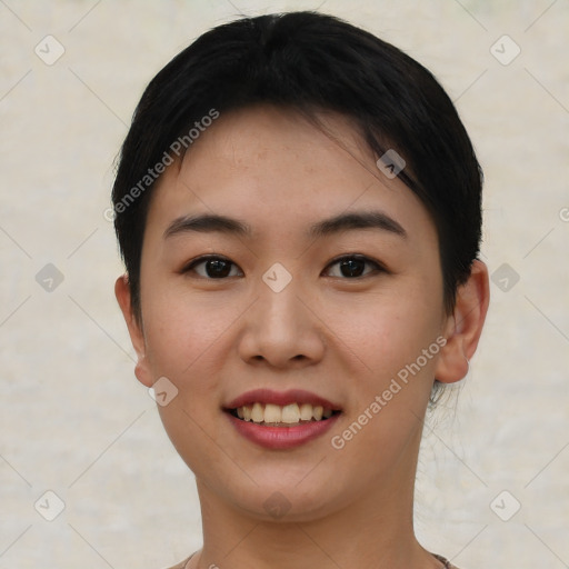 Joyful asian young-adult female with short  black hair and brown eyes