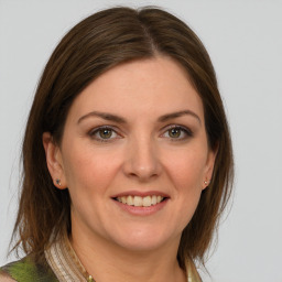 Joyful white young-adult female with medium  brown hair and green eyes