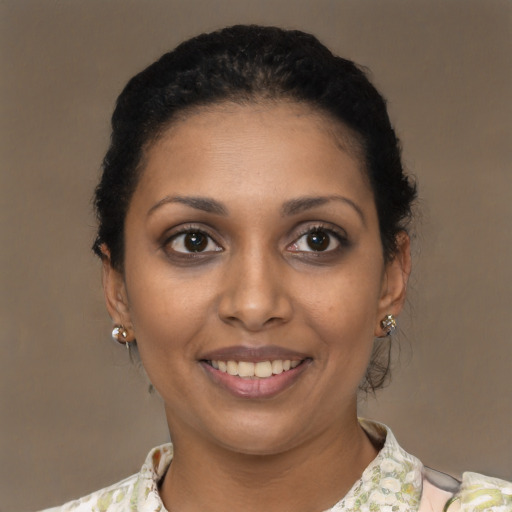 Joyful black young-adult female with short  brown hair and brown eyes