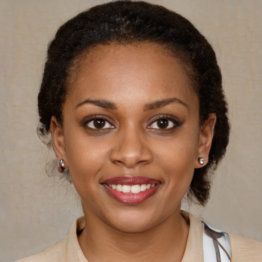 Joyful black young-adult female with medium  brown hair and brown eyes