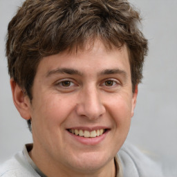 Joyful white adult male with short  brown hair and grey eyes