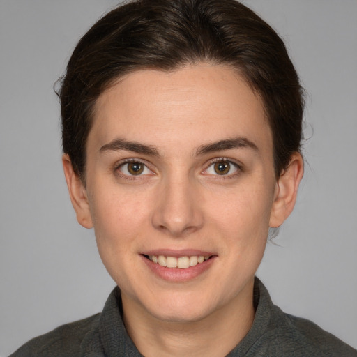 Joyful white young-adult female with short  brown hair and brown eyes